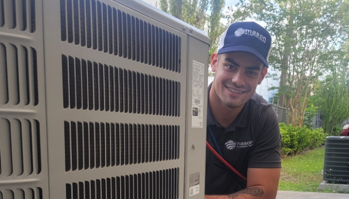 Technician With Hvac Condensor Outside